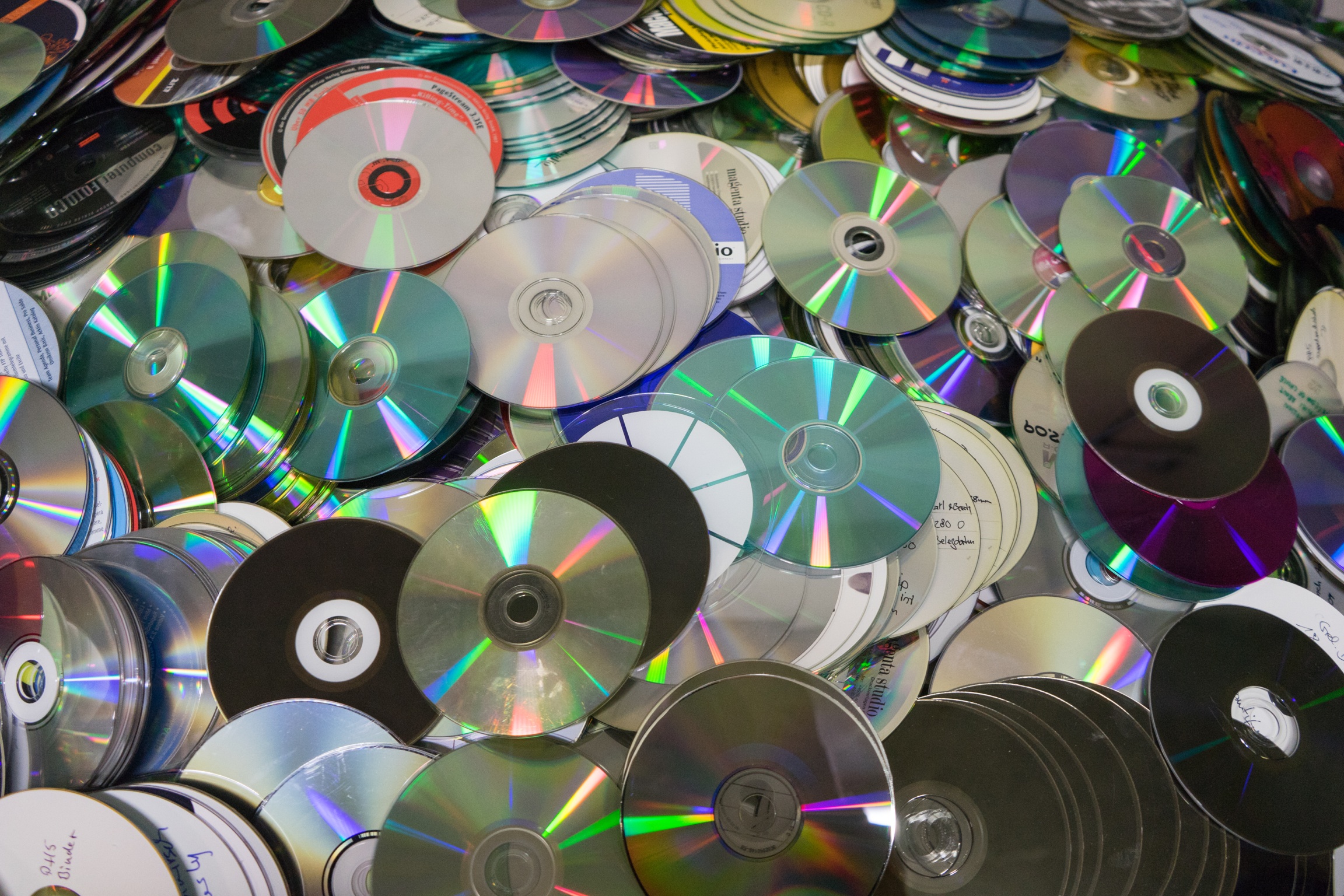 Close-up of compact discs being recycled
